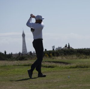 Content Creation: A picture of a golfer teeing off at a golf event.